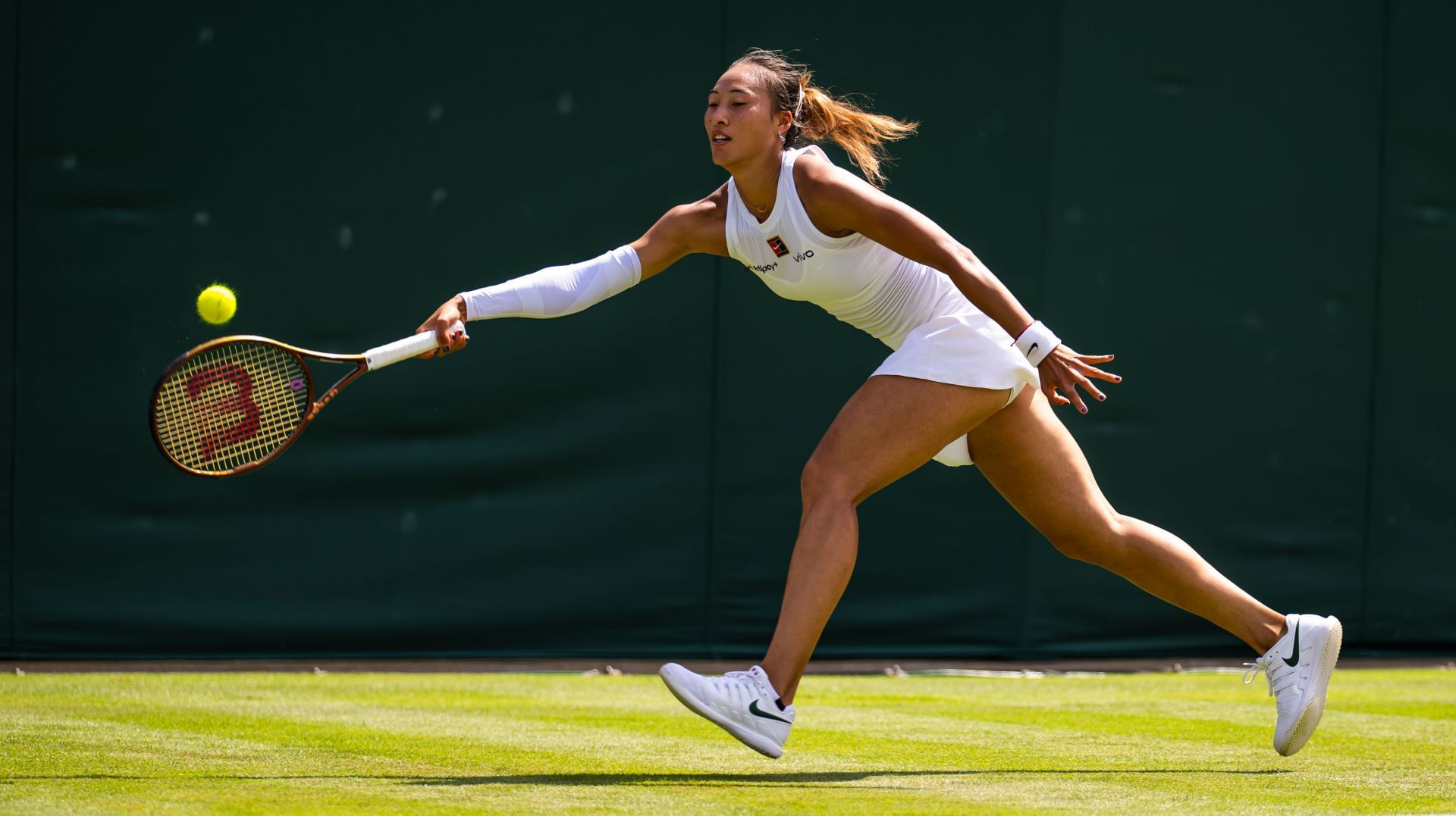 Zheng Qinwen retrieves a ball at Wimbledon 2025 | Image Source: Getty