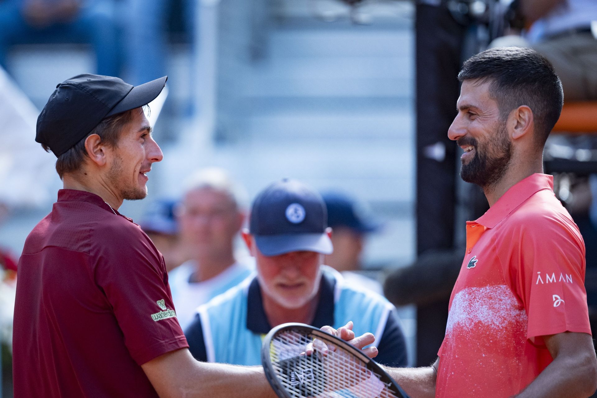 Matteo Arnaldi (left) and Novak Djokovic (right) at the 2025 Madrid Open (Source: Getty)