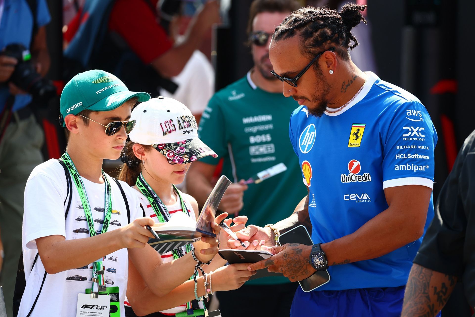 Ferrari&#039;s Lewis Hamilton giving an autograph to a fan at the F1 GP of Italy race weekend - Source: Getty