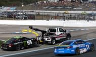 Ty Gibbs (54) towed as Denny Hamlin (11) drives past at New Hampshire Motor Speedway. Source: Getty
