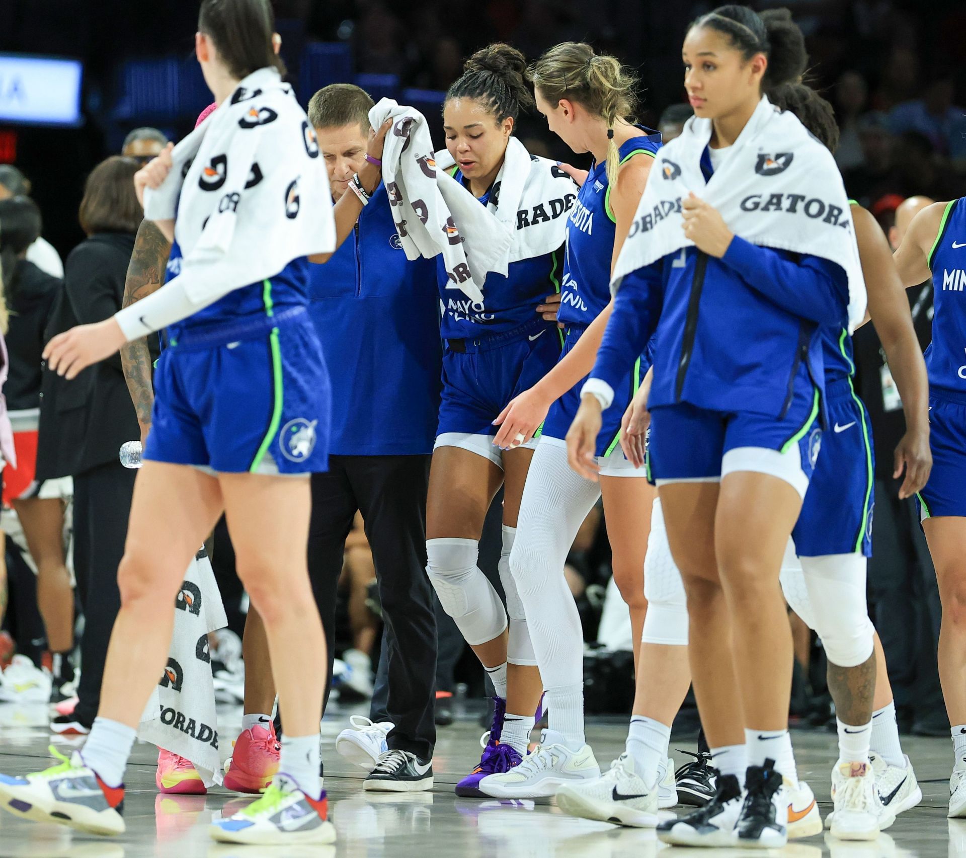 Napheesa Collier (C) #24 of the Minnesota Lynx is escorted off of the floor after she was hurt on a play against the Las Vegas Aces - Source: Getty