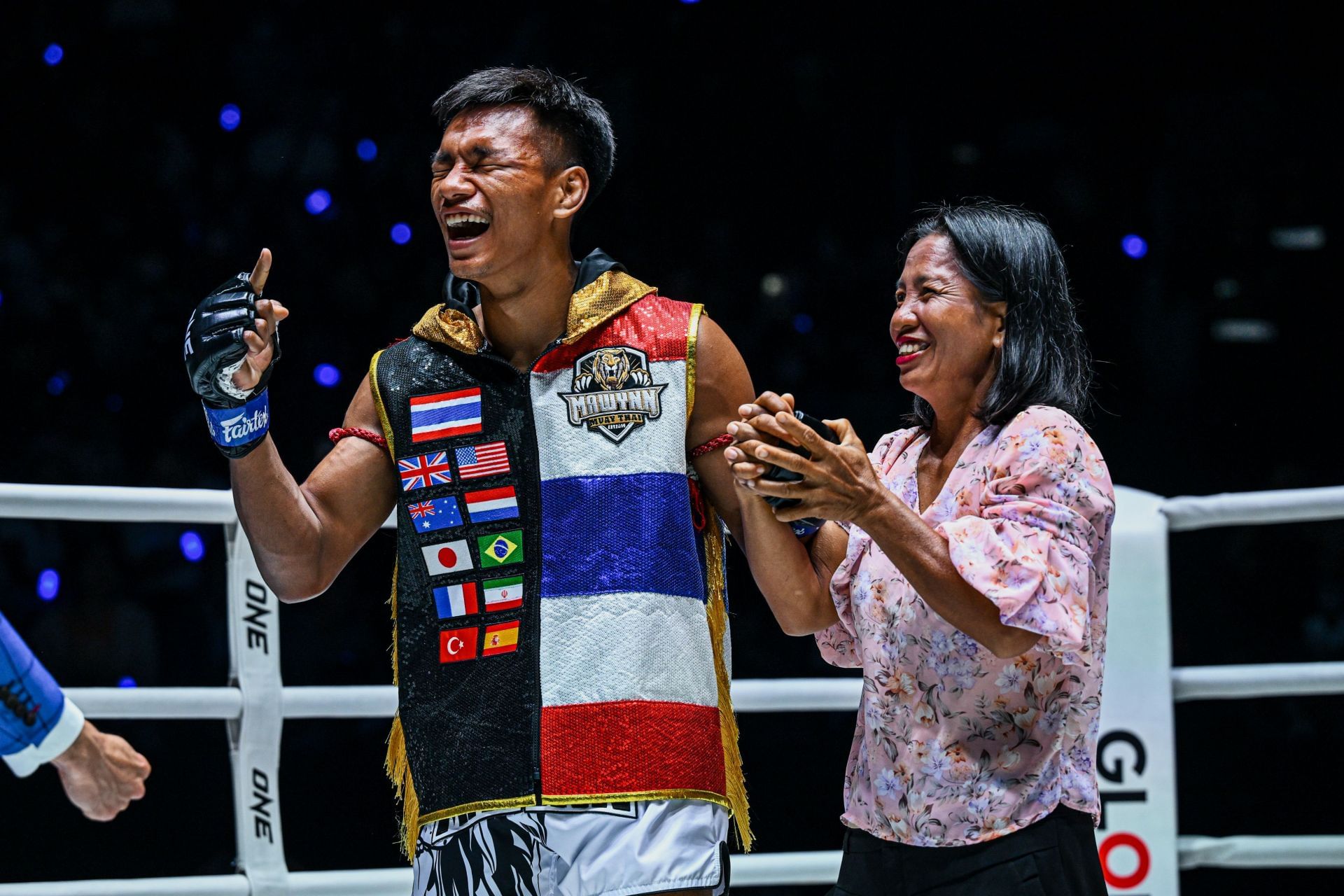 Thai striker Shadow Singha Mawynn (left) celebrates his victory alongside his mum. [Image: ONE Championship]