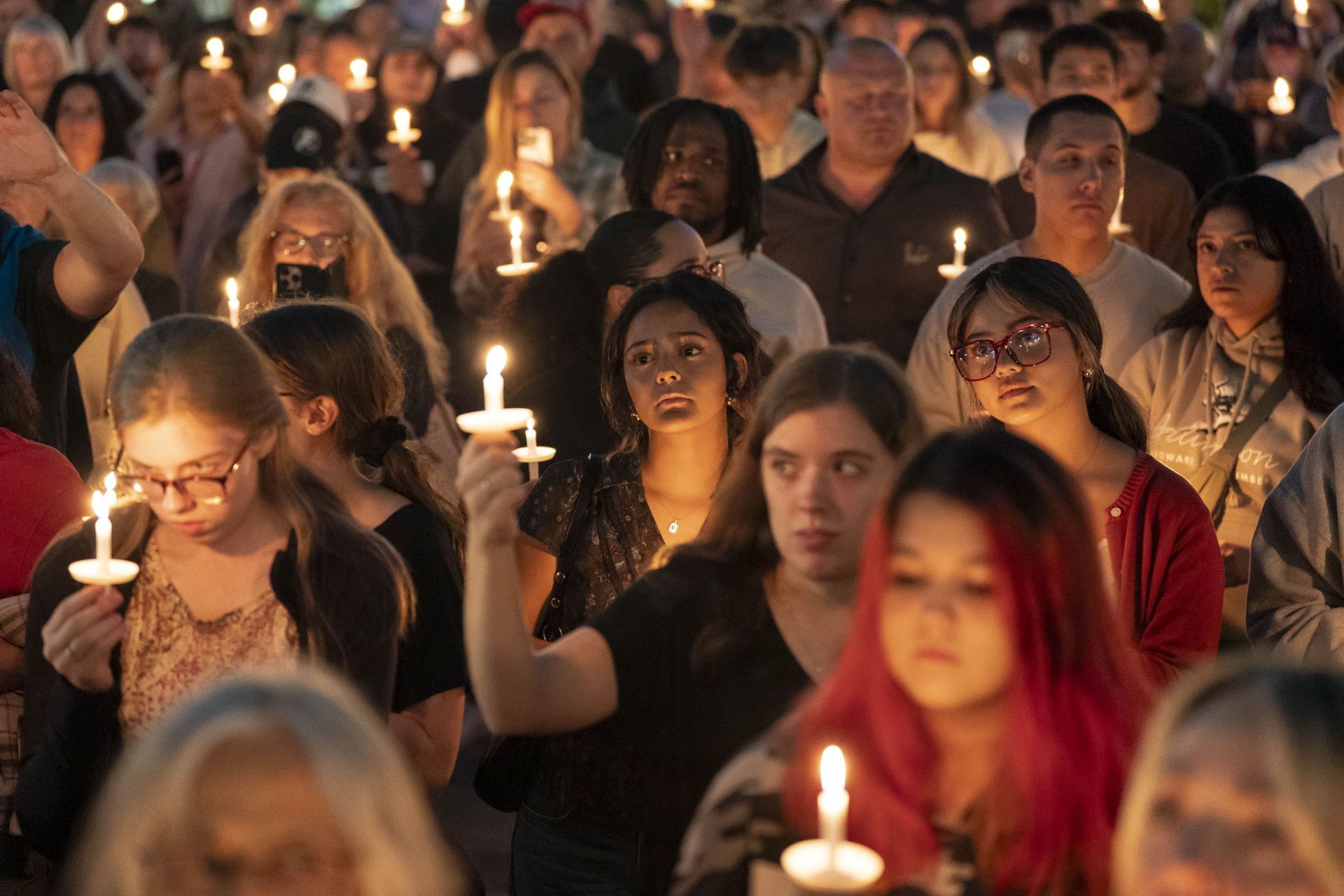 Attendees hold candles during a candlelight vigil and prayer event for Charlie Kirk (Image via Getty)
