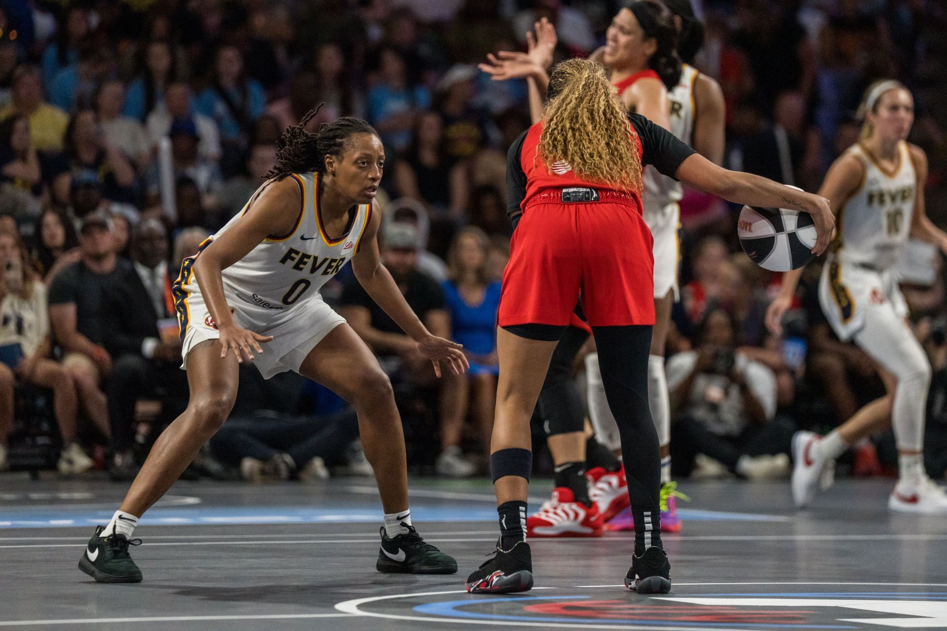 Kelsey Mitchell #0 of the Fever defends against Jordin Canada #3 of the Atlanta Dream - Source: Getty