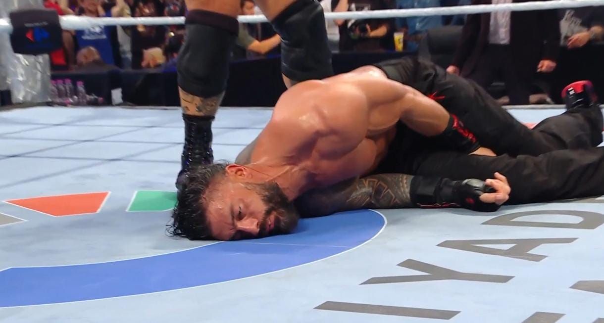 Roman Reigns attacked by The Vision. [Image credits: WWE on X/Twitter)