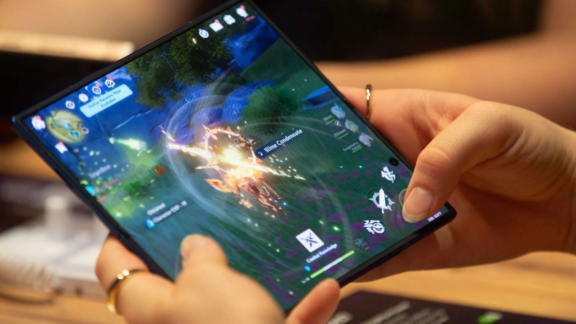 A fairgoer tries gaming on the Galaxy Z Fold7 at the Gamescom 2025 Samsung booth (Image via Ying Tang/NurPhoto via Getty Images)