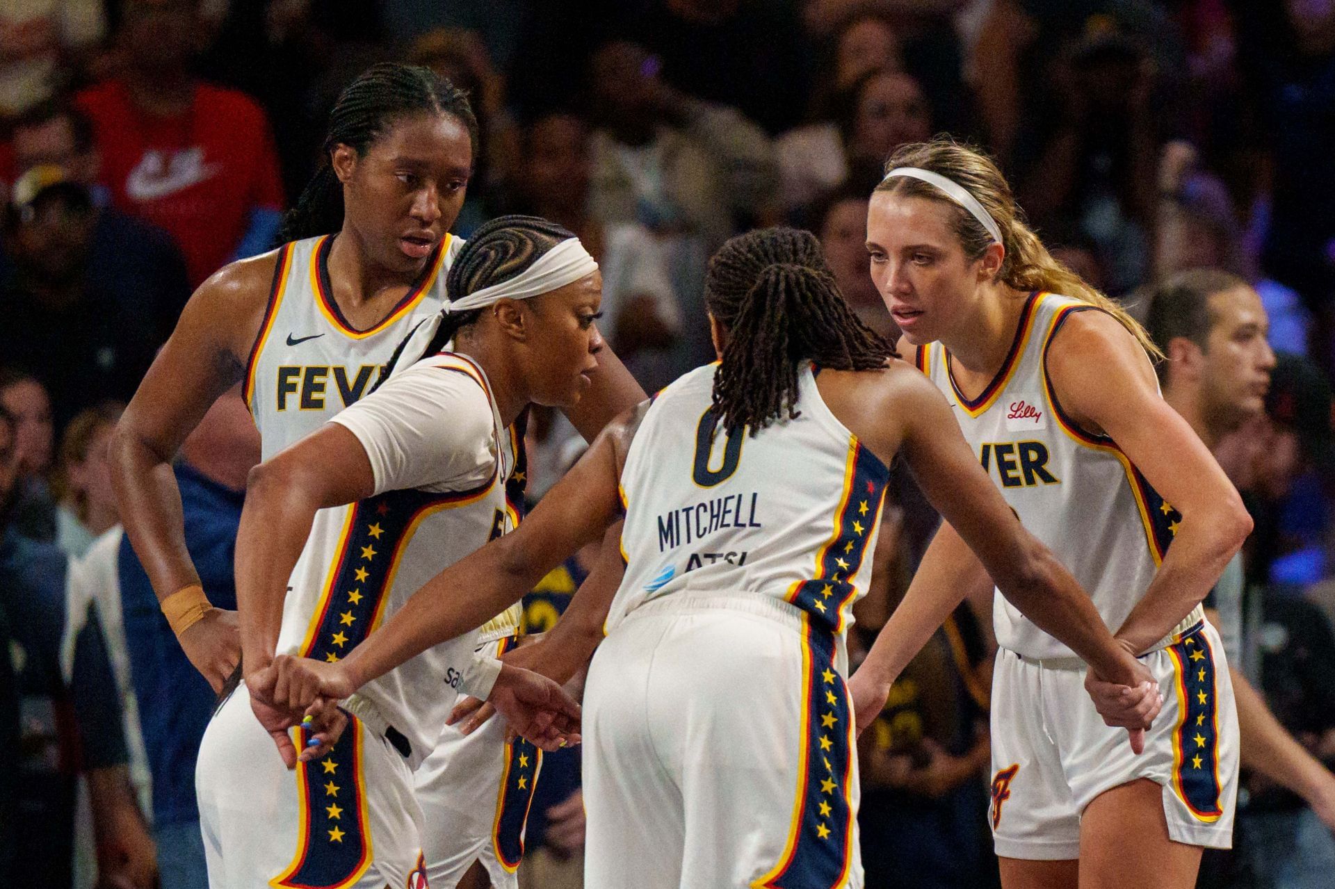 Aliyah Boston #7 of the Indiana Fever, Odyssey Sims #1 of the Indiana Fever, Kelsey Mitchell #0 of the Indiana Fever, and Lexie Hull #10 of the Indiana Fever huddle on the floor - Source: Getty