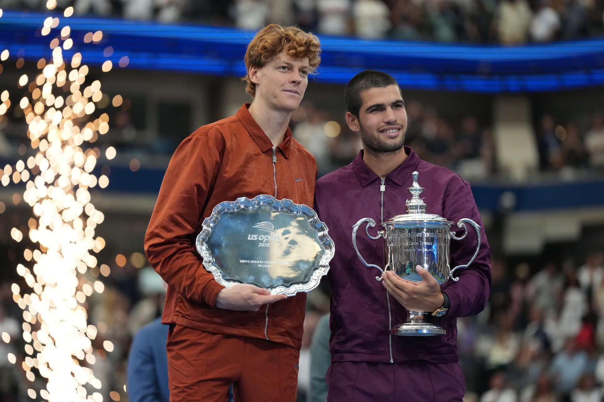 Jannik Sinner (left) and Carlos Alcaraz (right) pose with the men&#039;s singles runner-up and winner&#039;s trophies respectively at the 2025 US Open (Source: Getty)