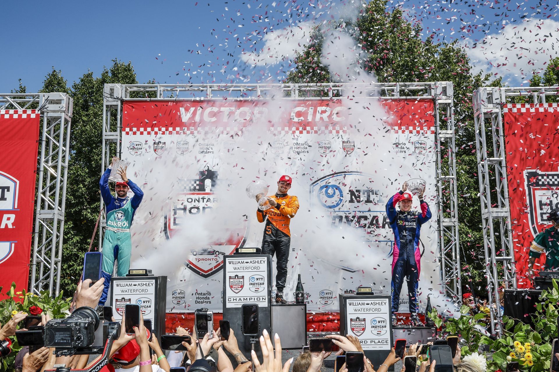 Rinus Veekay, Pato O&#039;Ward, and Kyffin Simpson celebrate on the IndyCar podium in Toronto - Source: Getty