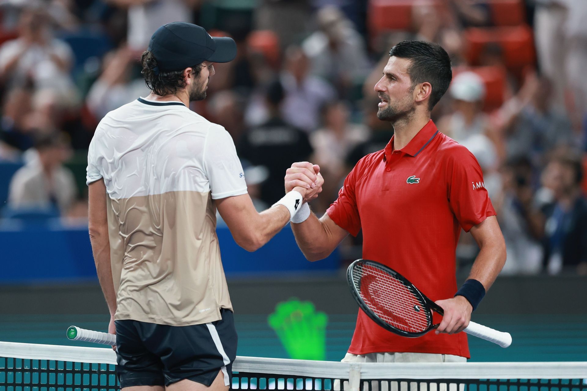 Valentin Vacherot (left) and Novak Djokovic (right) shake hands at the net after the Monegasque&#039;s victory against the Serb in the semifinals of the 2025 Shanghai Masters (Source: Getty)