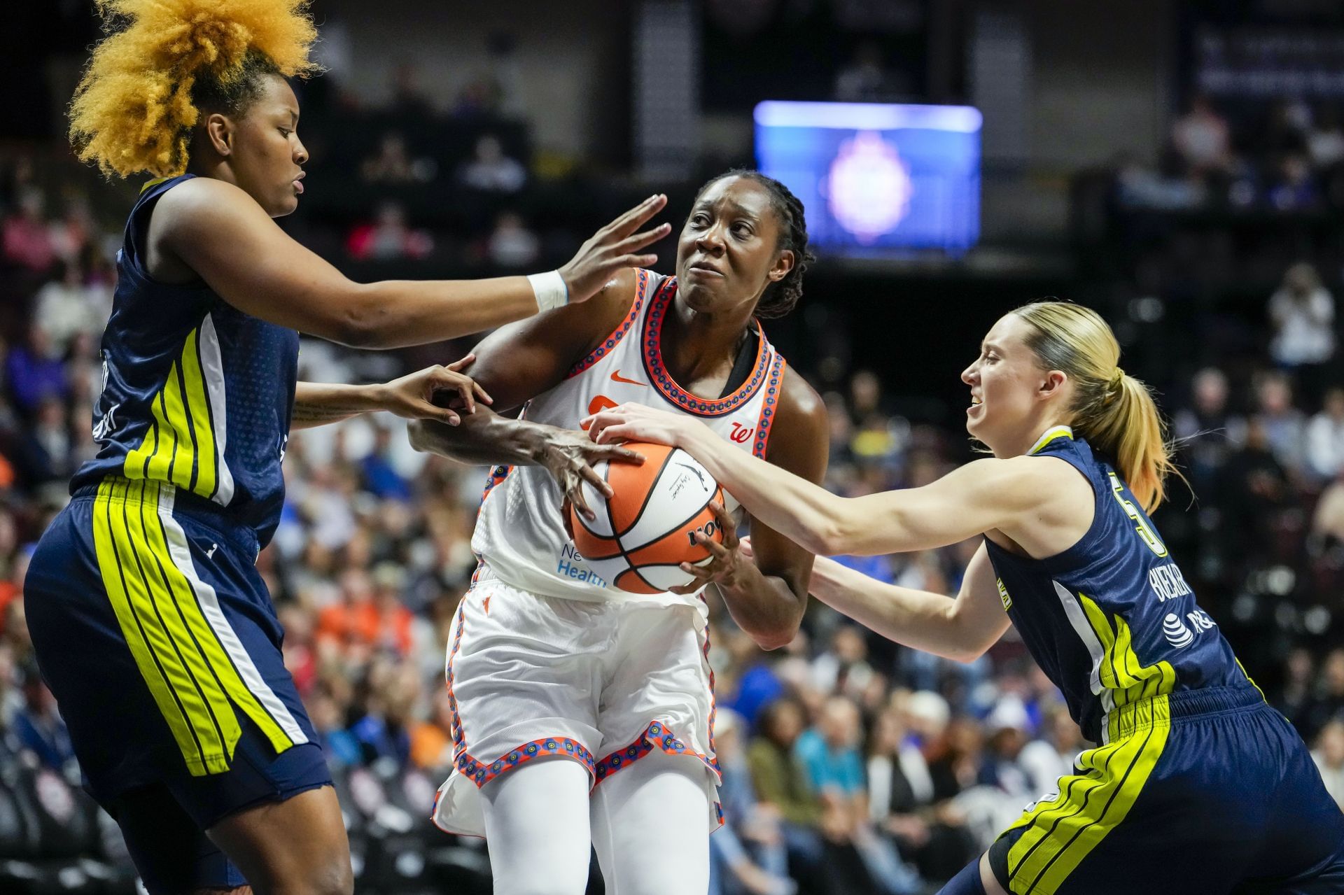 Tina Charles #31 of the Connecticut Sun is double-teamed by former Wings star NaLyssa Smith #1 and ROTY Paige Bueckers #5 during the first half at Mohegan Sun Arena on May 27, 2025 in Uncasville, Connecticut. - Source: Getty