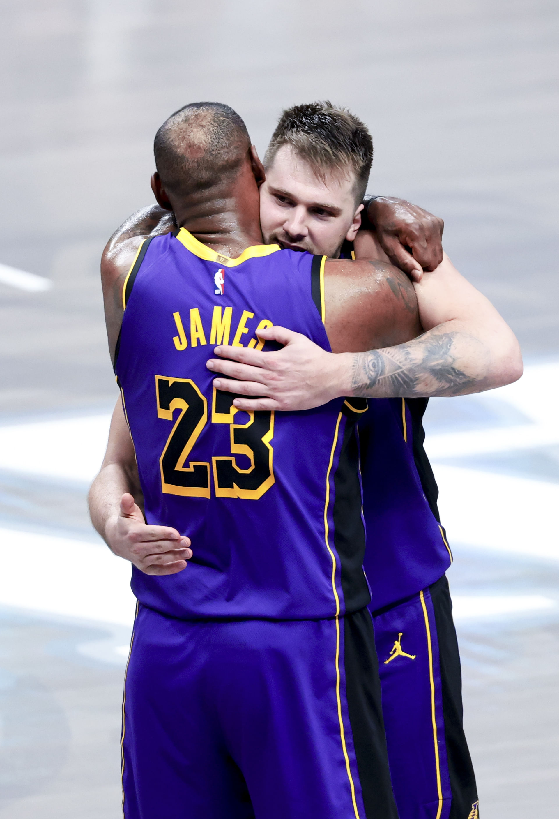 Los Angeles Lakers guard Doncic (77) celebrates with Los Angeles Lakers forward LeBron James (23) during the fourth quarter against the Dallas Mavericks at American Airlines Center. Mandatory Credit: Kevin Jairaj-Imagn Images