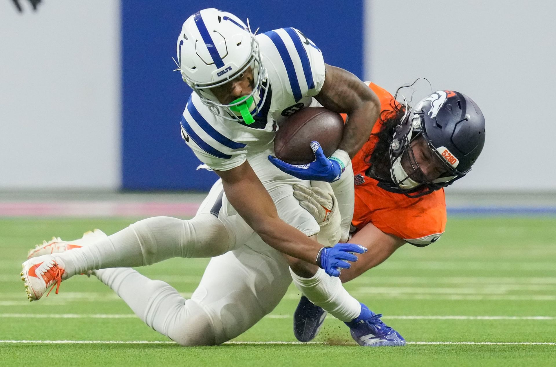 Josh Downs gets tackled by Broncos defender - Source: Imagn