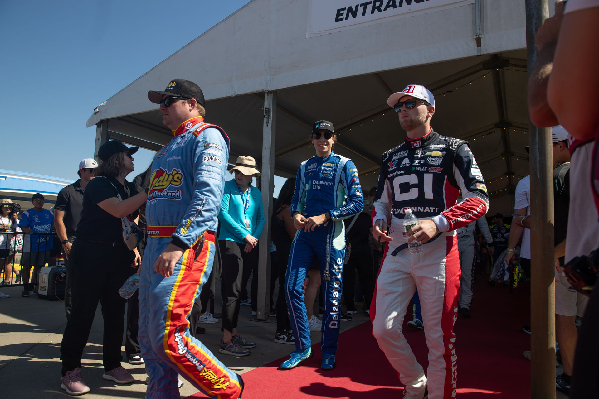 (L-R) Cole Custer, Carson Hocevar, and William Byron at the Kansas drivers&rsquo; meeting. Source: Imagn