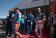 (L-R) Cole Custer, Carson Hocevar, and William Byron at the Kansas drivers’ meeting. Source: Imagn