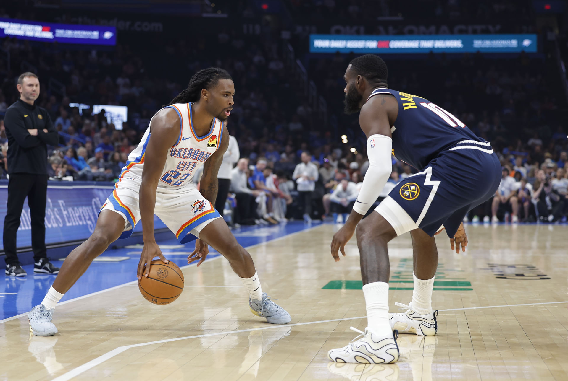 Thunder guard Cason Wallace (22) dribbles down the court as Denver Nuggets guard/forward Tim Hardaway Jr. (10) defends during the second half at Paycom Center. Mandatory Credit: Alonzo Adams-Imagn Images