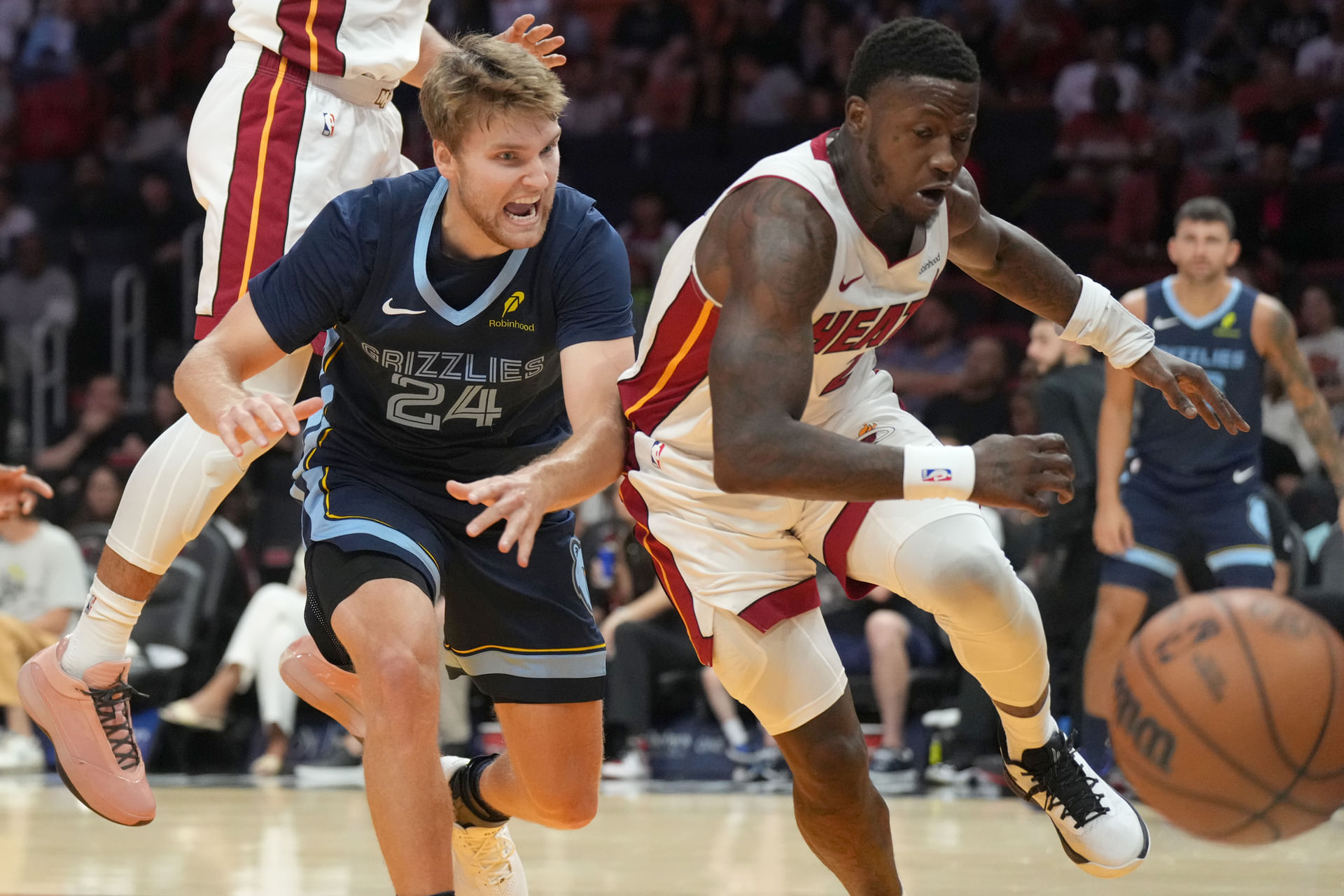 Memphis Grizzlies guard Cam Spencer (24) and Miami Heat guard Rozier (2) battle for a loose ball during the second half at Kaseya Center. Mandatory Credit: Jim Rassol-Imagn Images