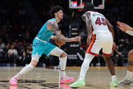 Oct 28, 2025; Miami, Florida, USA; Charlotte Hornets guard Lamelo Ball (1) dribbles the basketball as Miami Heat guard Davion Mitchell (45) defends during the second quarter at Kaseya Center. Mandatory Credit: Sam Navarro-Imagn Images