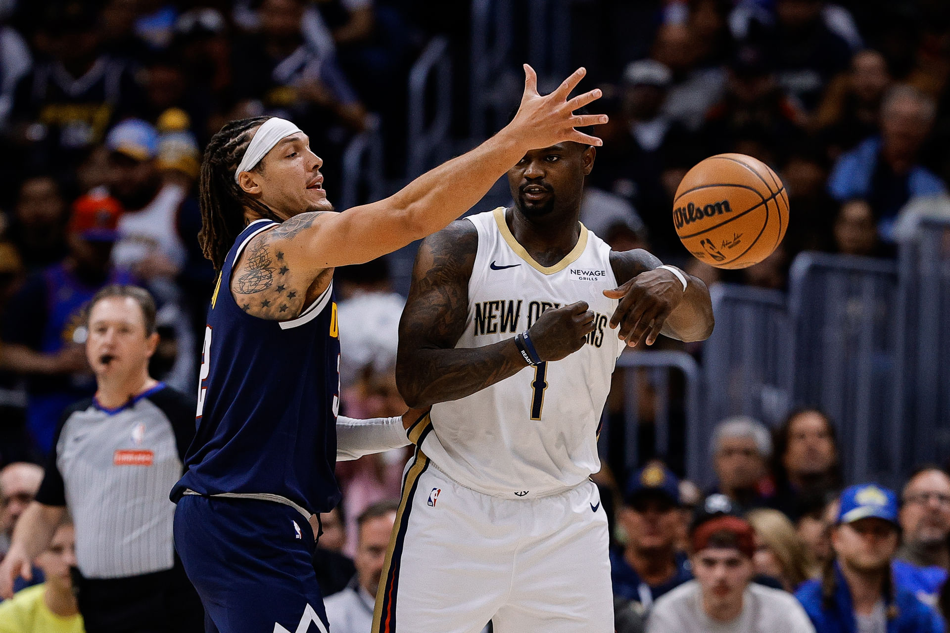 Oct 29, 2025; Denver, Colorado, USA; New Orleans forward Zion Williamson (1) passes the ball as Denver Nuggets forward Aaron Gordon (32) defends in the third quarter at Ball Arena. Mandatory Credit: Isaiah J. Downing-Imagn Images