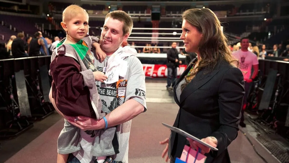 Connor Michalek and his father with Stephanie McMahon (Credit: WWE.com)
