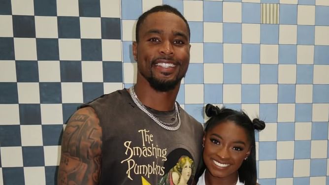 Simone Biles poses in all black outfit while husband Jonathan Owens rocks Versace shirt for special date night