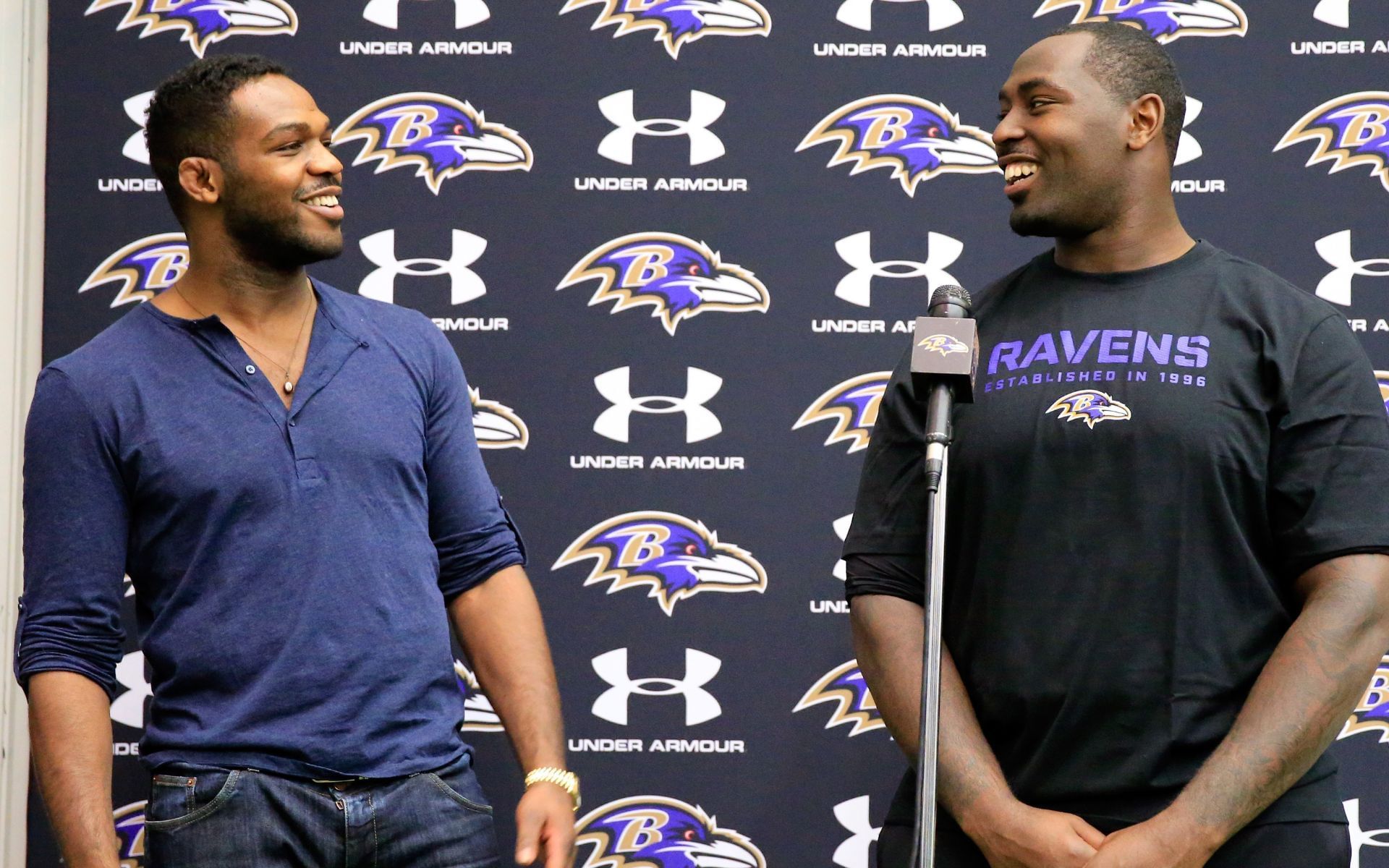 Jon Jones (left) joking with his brother Arthur (right) during a press conference at the Baltimore Ravens