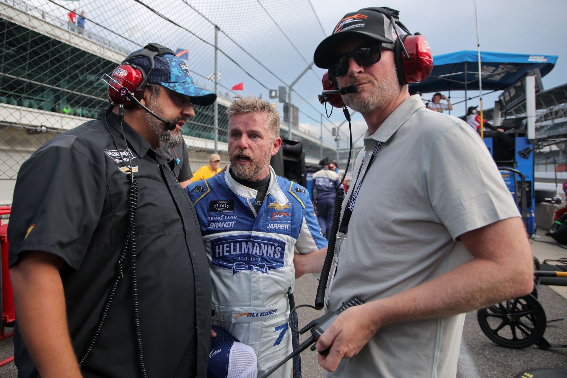 Justin Allgaier speaks to crew chief Jim Pohlman (L) and Hall of Famer and JR Motorsports team owner, Dale Earnhardt Jr - Source: Getty