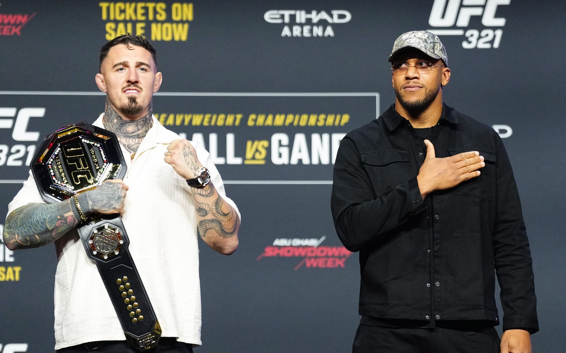 Tom Aspinall (left) and Ciryl Gane (right) posing for photos during their press conference at the Accor Arena in September. [Image courtesy: Getty Images]