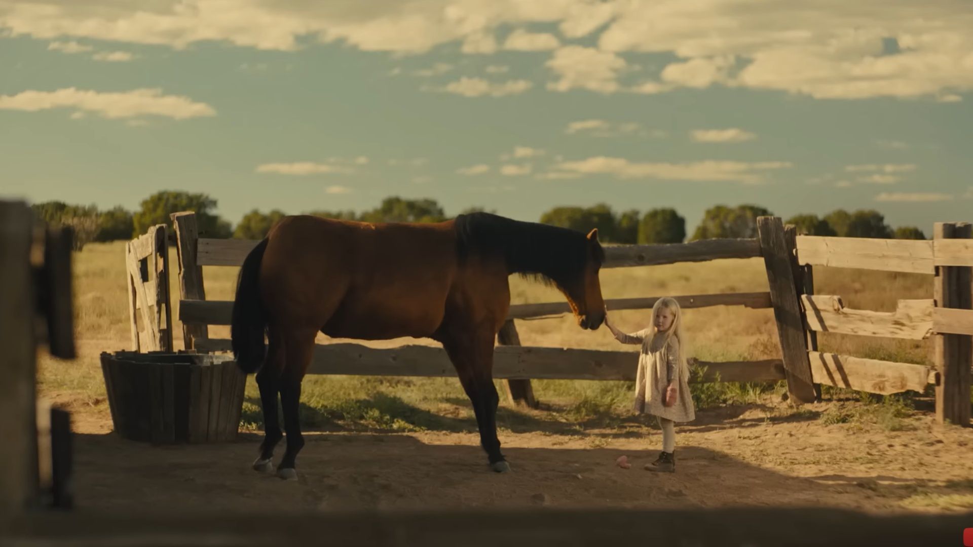 The young girl reaches out to a horse in a quiet moment that contrasts innocence and danger in Killing Faith. (Image via Shout! Studio)