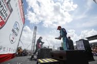 Rinus Veekay sprays celebratory champagne on the podium at the NTT INDYCAR Series Ontario Honda Dealers Indy Toronto - Source: Getty