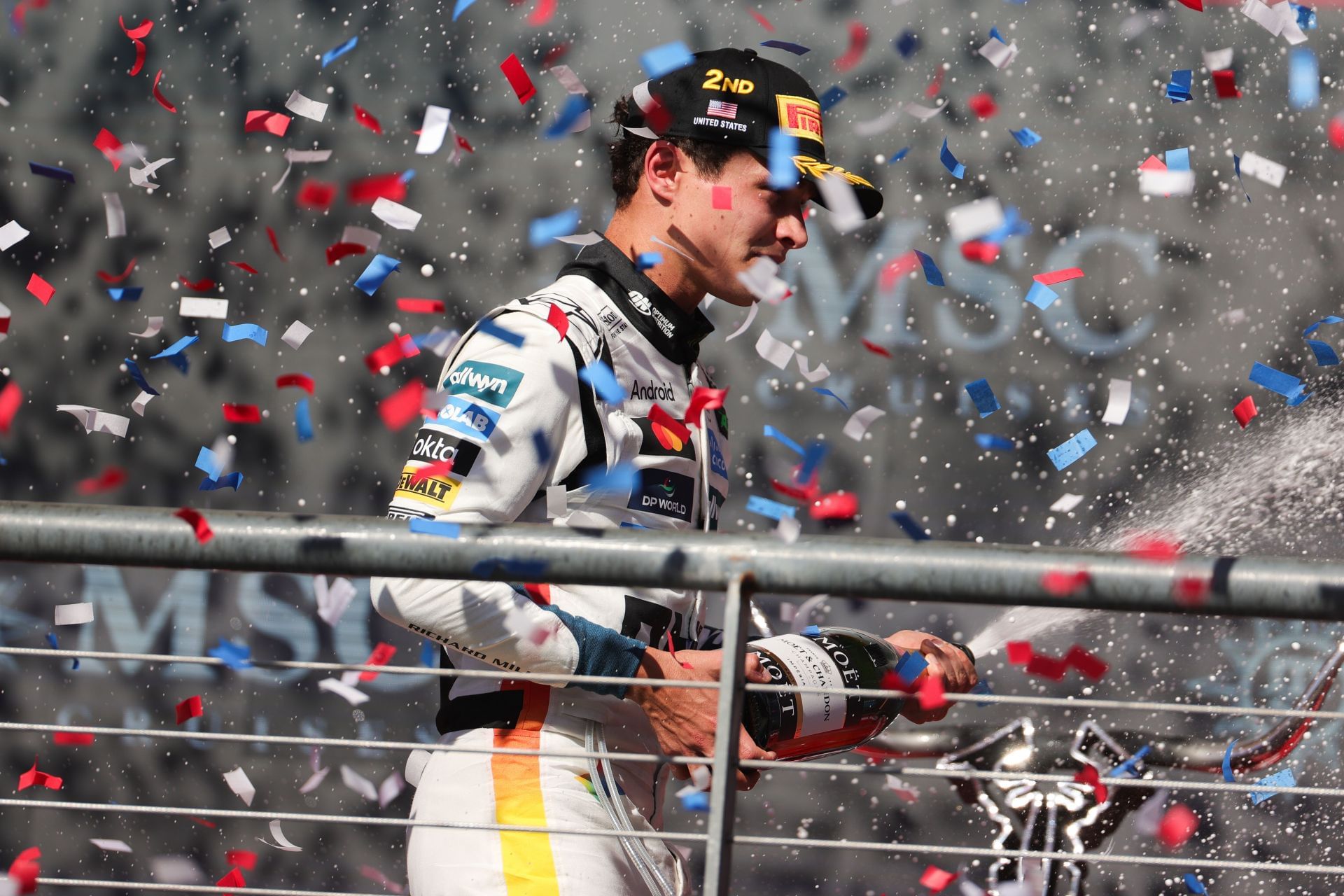 McLaren&#039;s Lando Norris celebrating his P2 finish on the podium at the 2025 F1 Grand Prix of the United States - Source: Getty