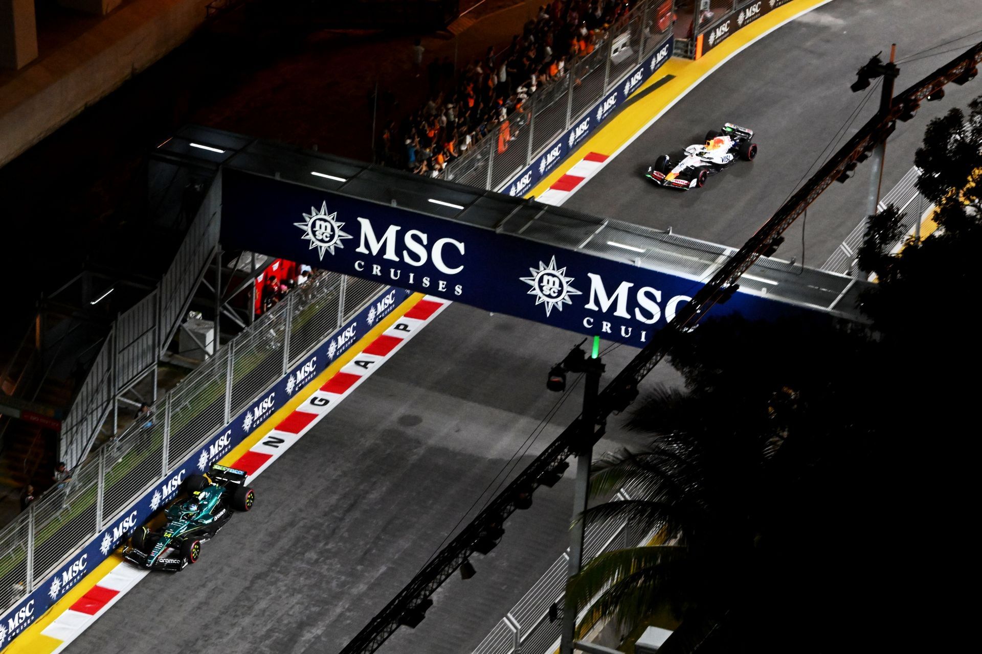Fernando Alonso (14) leads Isack Hadjar (6) during the F1 Grand Prix of Singapore. Source: Getty