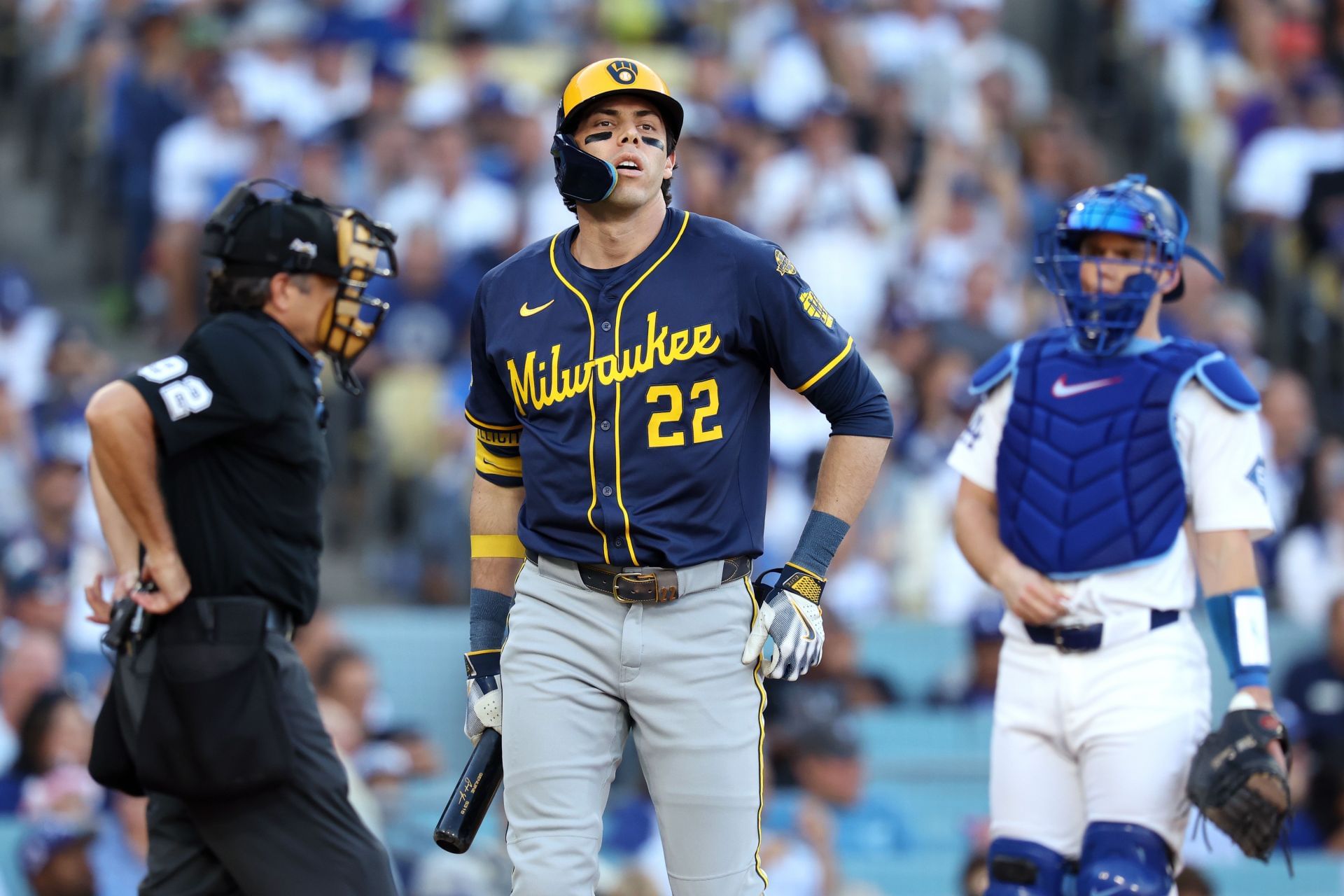 Christian Yelich walks back to the dugout after striking out in Game Three of the NLCS against the Los Angeles Dodgers - Source: Getty