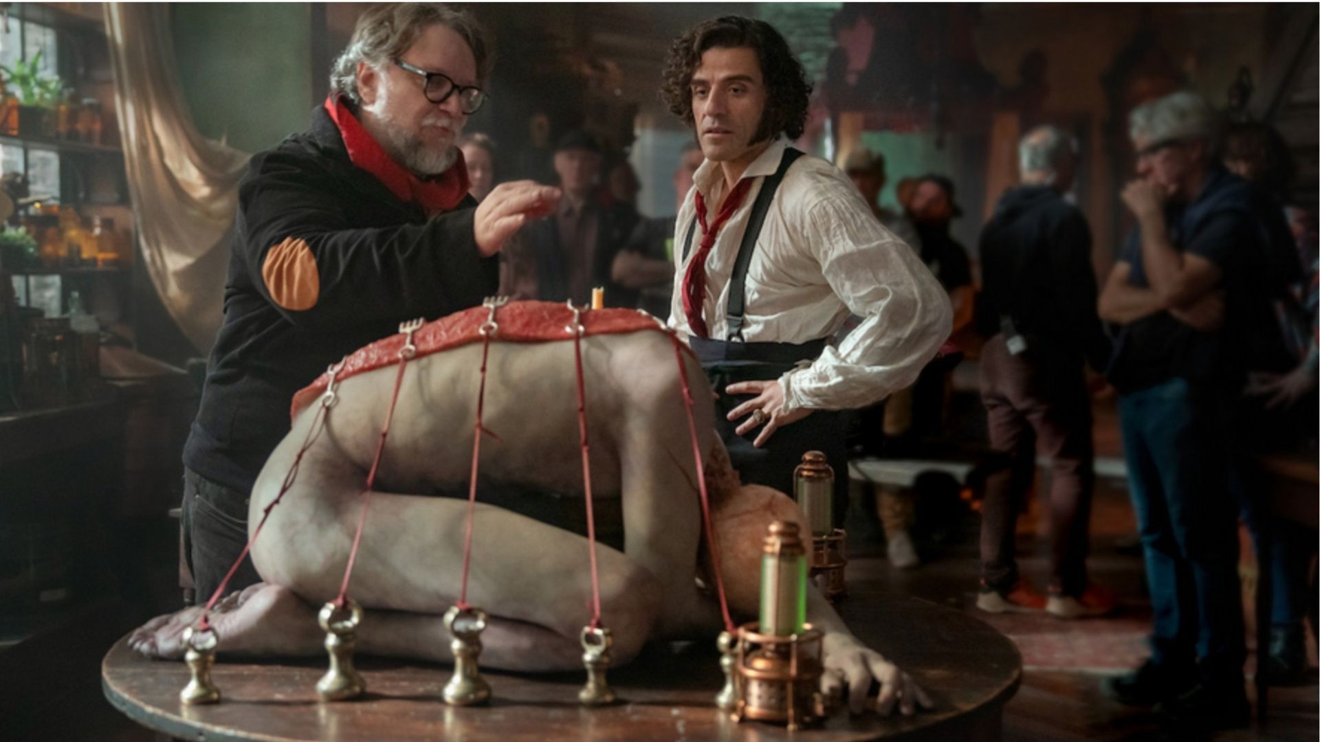 Guillermo del Toro directs Oscar Isaac in a pivotal laboratory scene from the Frankenstein trailer, showcasing the creation of the iconic creature (Image via Netflix)
