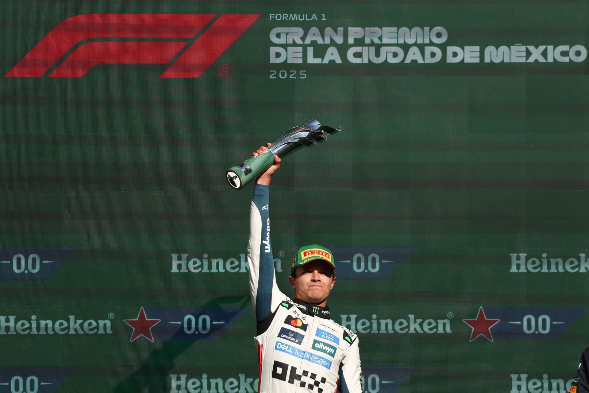 McLaren&#039;s Lando Norris lifting the first-place trophy at the podium for the F1 Grand Prix of Mexico City 2025 - Source: Getty
