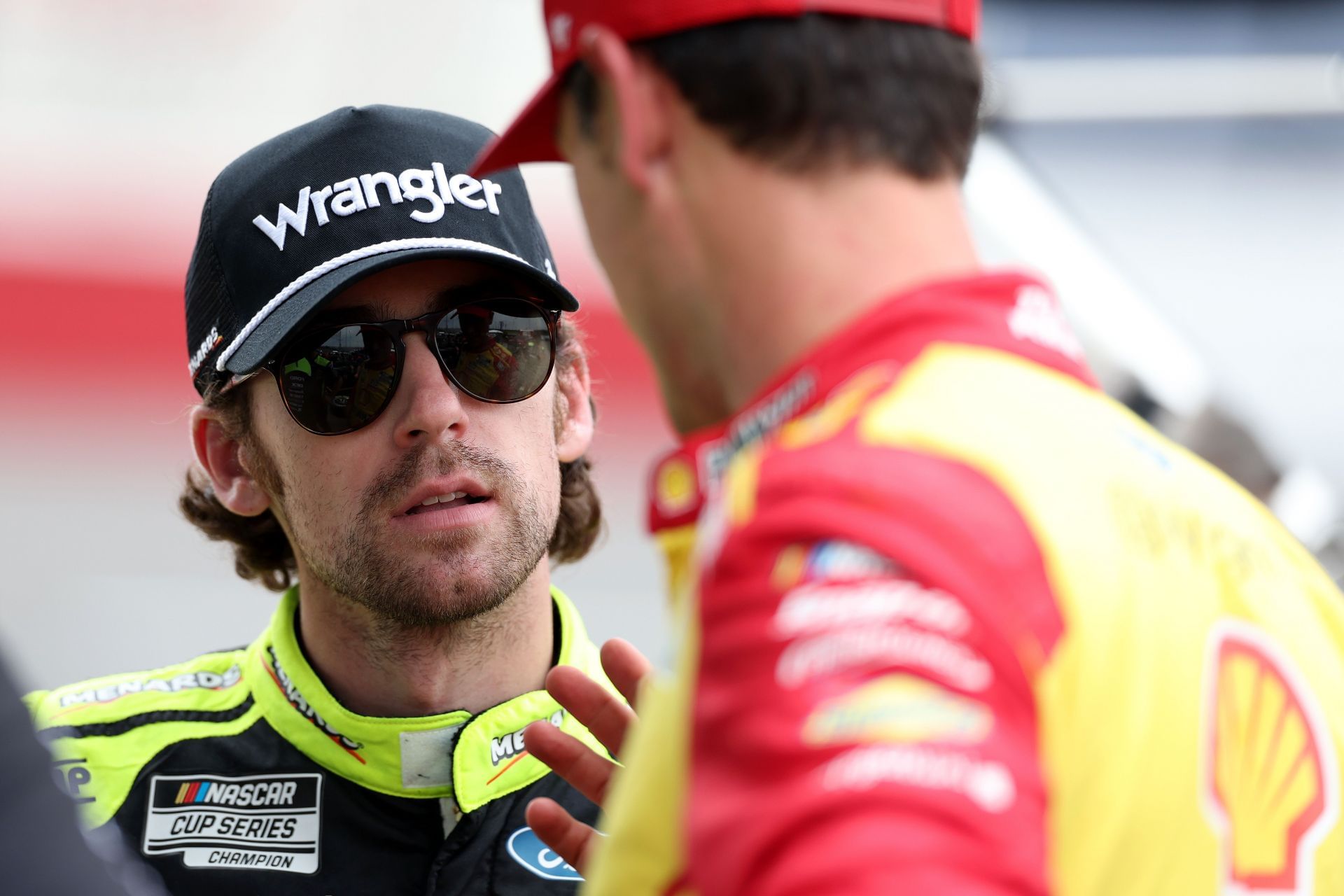 Team Penske&#039;s Ryan Blaney (L) speaks to Joey Logano at North Wilkesboro Speedway. Source: Getty
