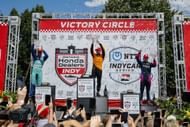 Rinus Veekay on the podium with Pato O'Ward and Kyffin Simpson at the NTT INDYCAR Series Ontario Honda Dealers Indy Toronto - Source: Getty