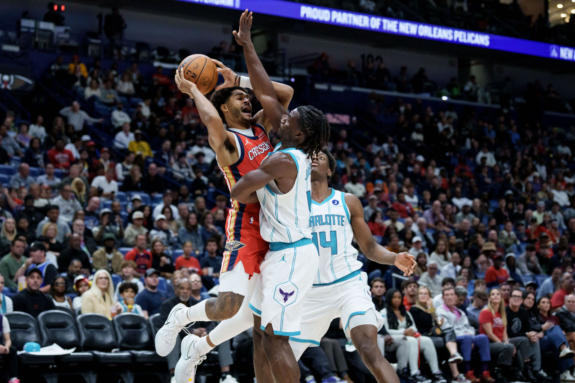 Nov 4, 2025; New Orleans, Louisiana, USA; New Orleans guard Jordan Poole (3) shoots against Charlotte Hornets guard Sion James (4) and forward Moussa Diabate (14) during the first half at Smoothie King Center. Mandatory Credit: Matthew Hinton-Imagn Images