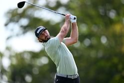 Max Homa poses before $70M-worth F1 driver's garage at the Las Vegas GP