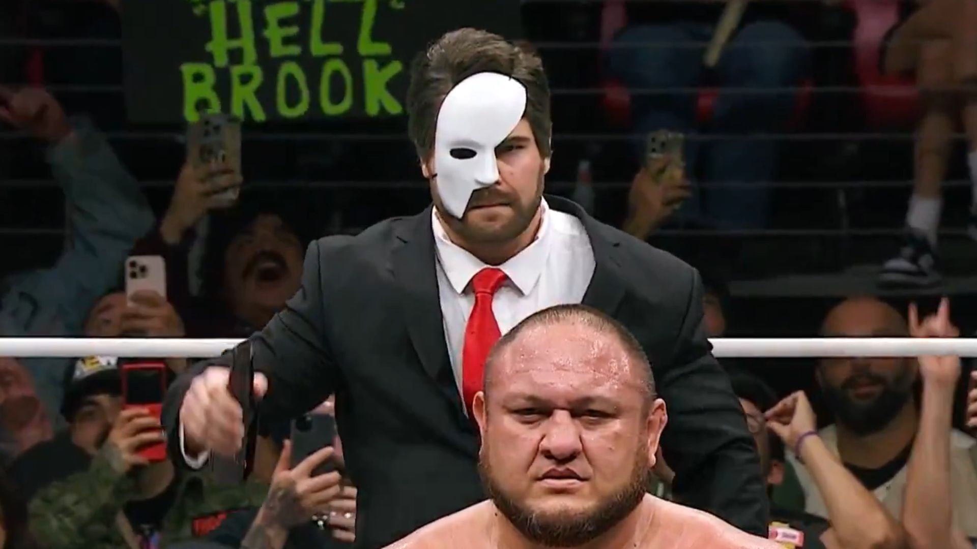 Hangman Page (disguised as Tony Schiavone) getting the drop on Samoa Joe on Fright Night Dynamite [Image via @AEW on X]