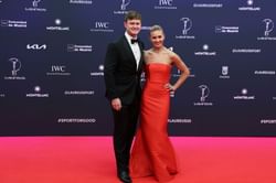 Ariarne Titmus poses in black bow-accent cocktail dress in special appearance with boyfriend Mack after retirement from swimming