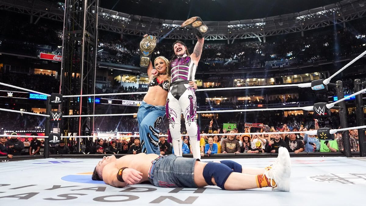 Liv Morgan and Dominik Mysterio standing tall over John Cena (Image Credits: WWE.com)
