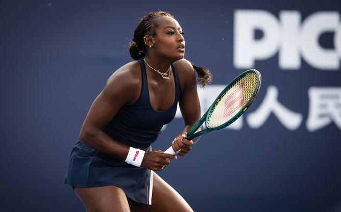 PICTURE: Alycia Parks poses in a black bikini as she enjoys refreshing drink during scenic tropical getaway