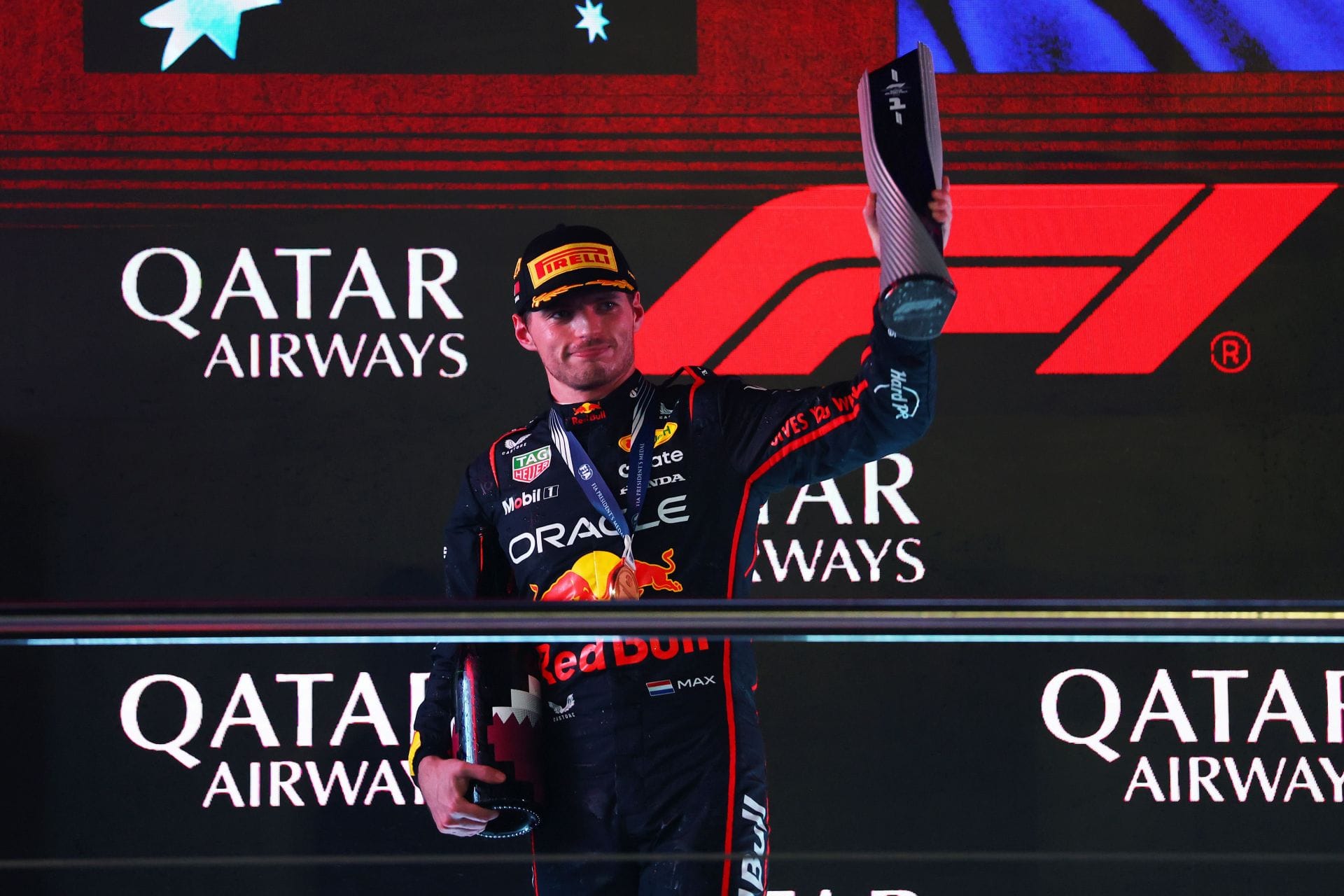 Race winner Max Verstappen of the Netherlands and Oracle Red Bull Racing on the podium with his trophy during the F1 Grand Prix of Qatar at Lusail International Circuit - Source: Getty
