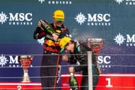 Red Bull's Max Verstappen (L) and Mercedes' Kimi Antonelli (R) celebrating on the podium of the 2025 F1 Grand Prix of Brazil - Source: Getty