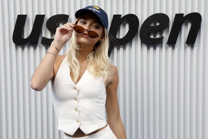 Olivia Dunne poses in athleisure outfit while flaunting leaopard print bag from multi-billion dollar brand