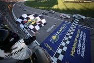 Chase Elliott (9) takes the checkered flag in the NASCAR Cup Series race at Kansas Speedway. Source: Getty