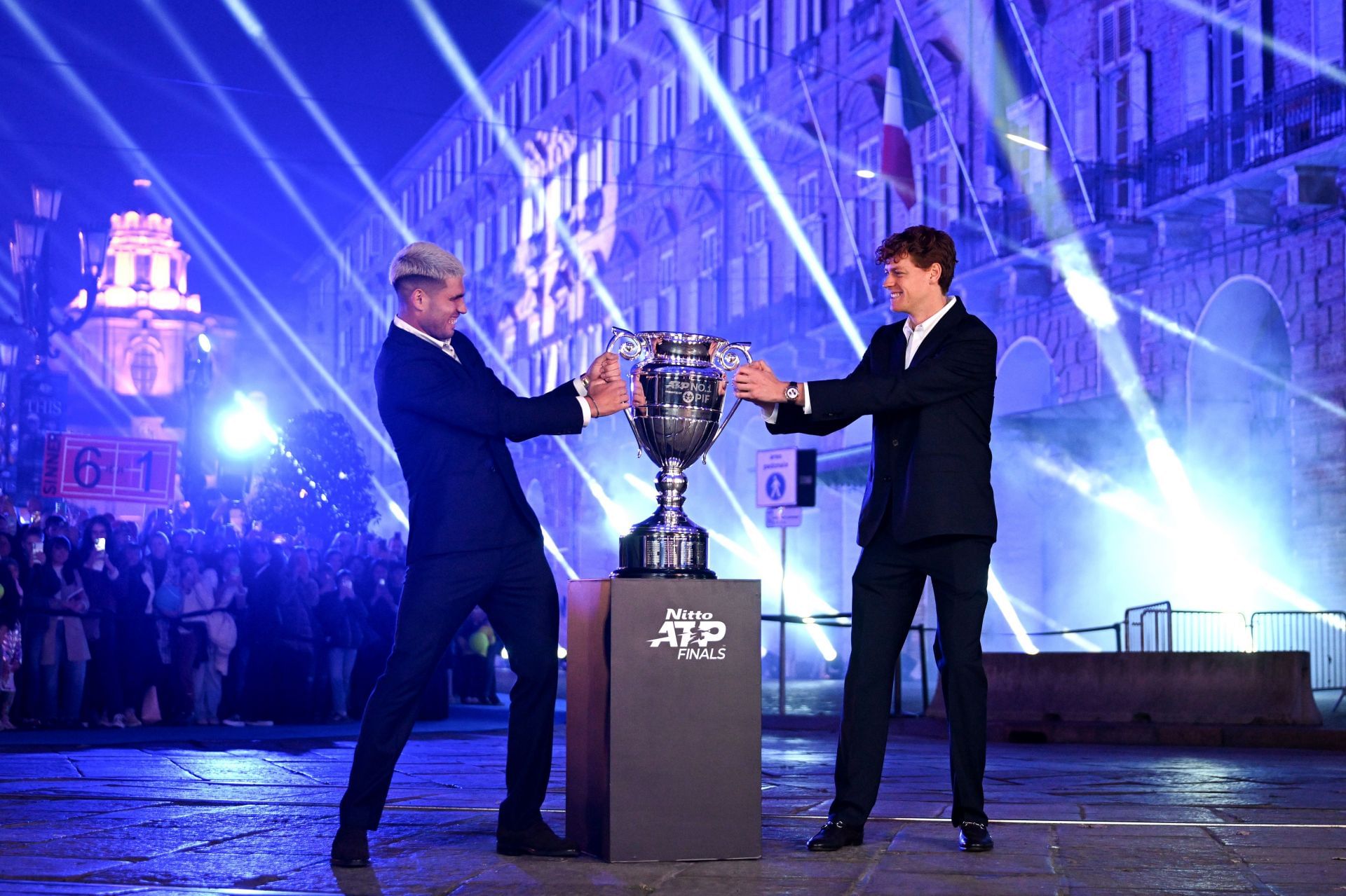 Carlos Alcaraz (left) and Jannik Sinner (right) strike a playful pose with the 2025 ATP Finals men's singles trophy ahead of the year-end event (Source: Getty)