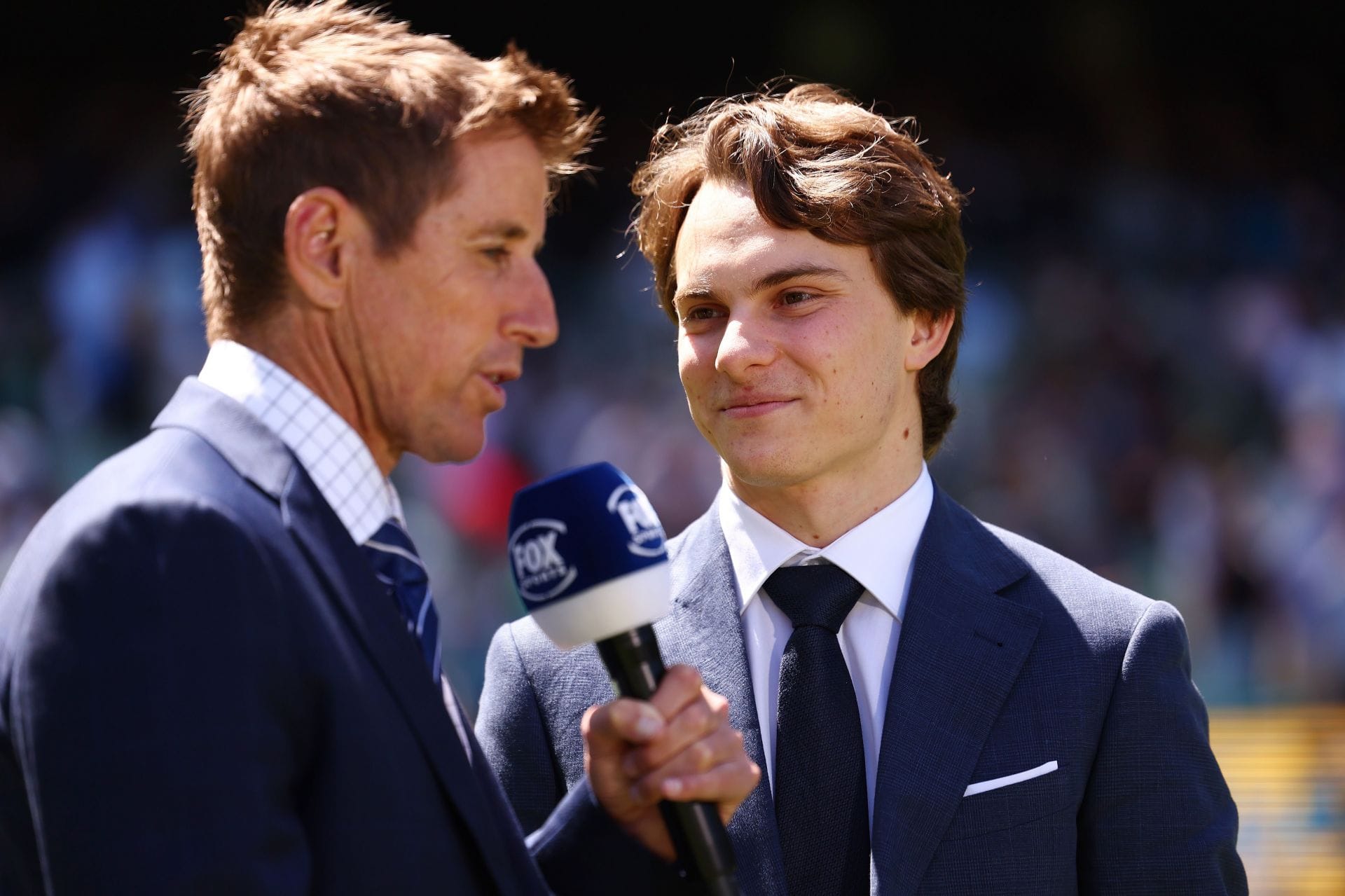 Oscar Piastri speaks to Mark Howard during day 2 of the 4th Ashes Test - Source: Getty