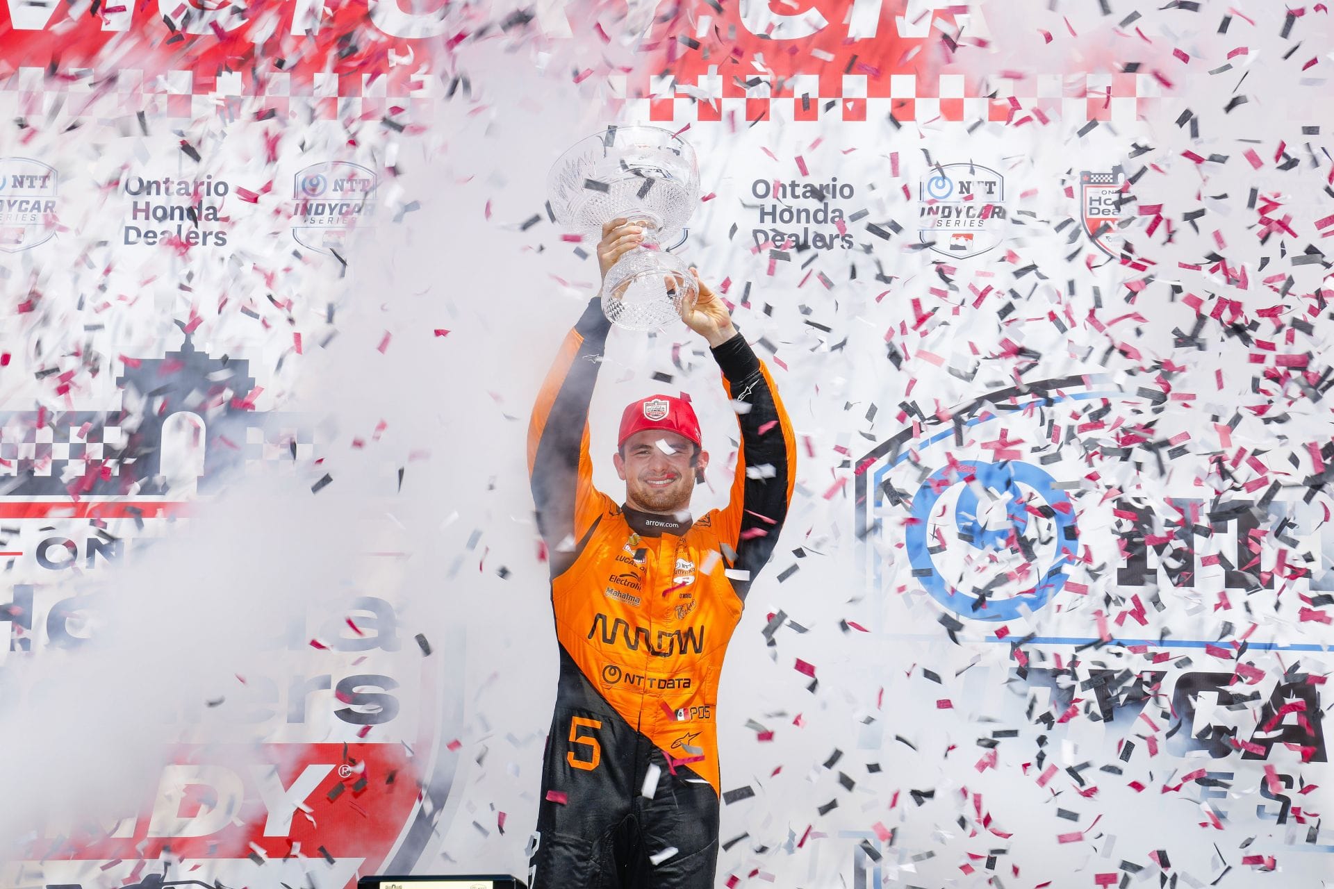 Pato O&#039;Ward celebrates on the podium after winning the 2025 IndyCar Ontario Honda Dealers Indy Toronto - Source: Getty